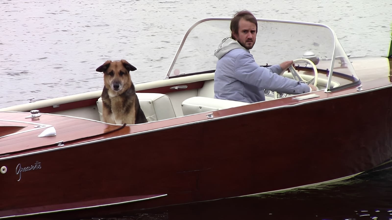 Man and dog in wooden boat