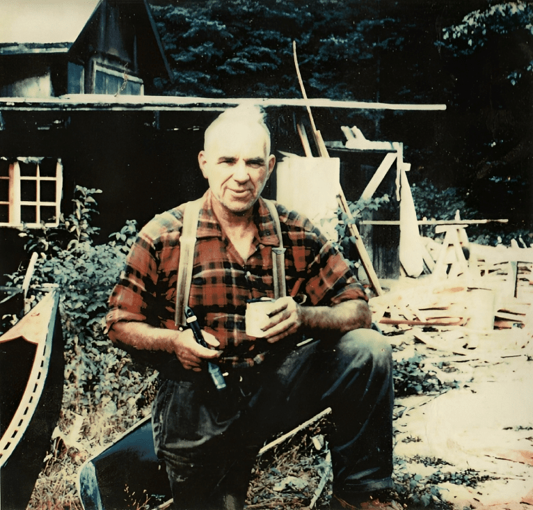 Lumberjack style man with tools outside cabin