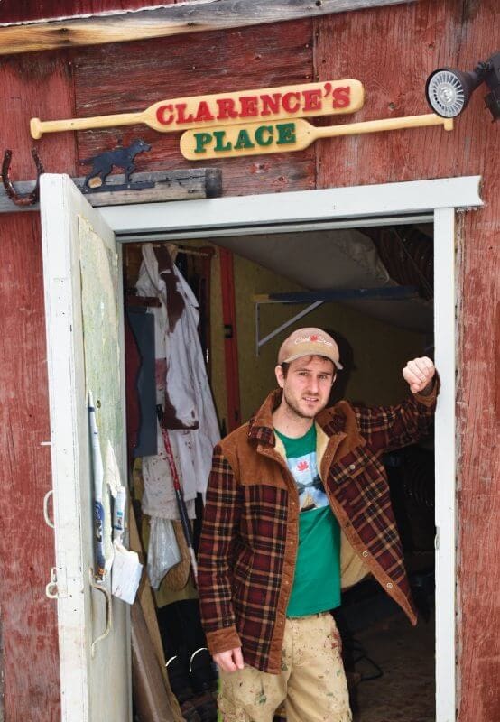 Man standing outside rustic building entrance