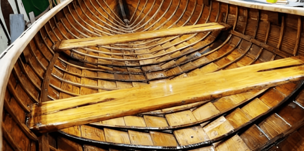 Shiny varnished wooden boat with seats