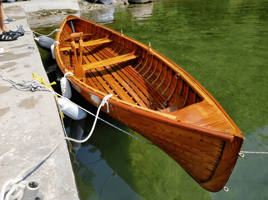 Wooden rowboat tied to dock