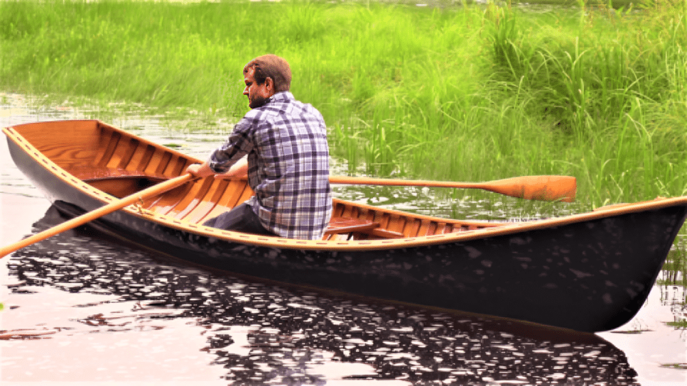 Person paddling in a black canoe