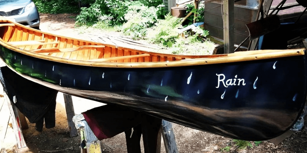 Black and wooden canoe in sunlight