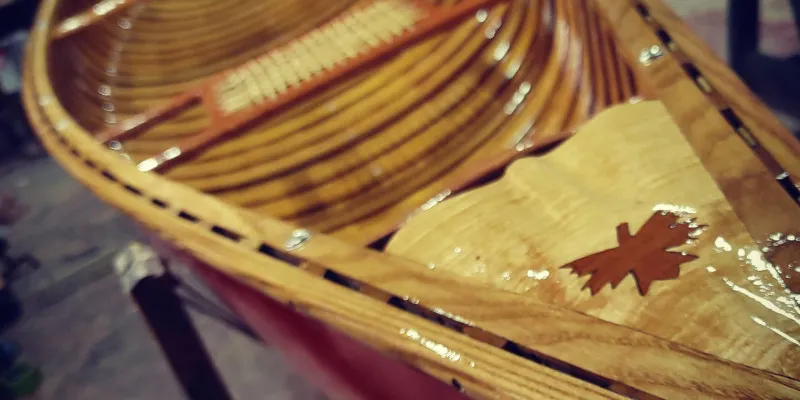 Polished wooden canoe with intricate detailing