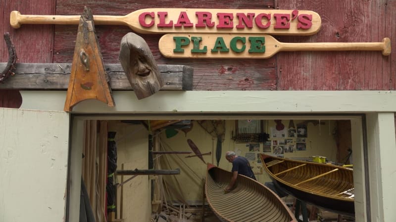 Clarence's Place sign with paddles