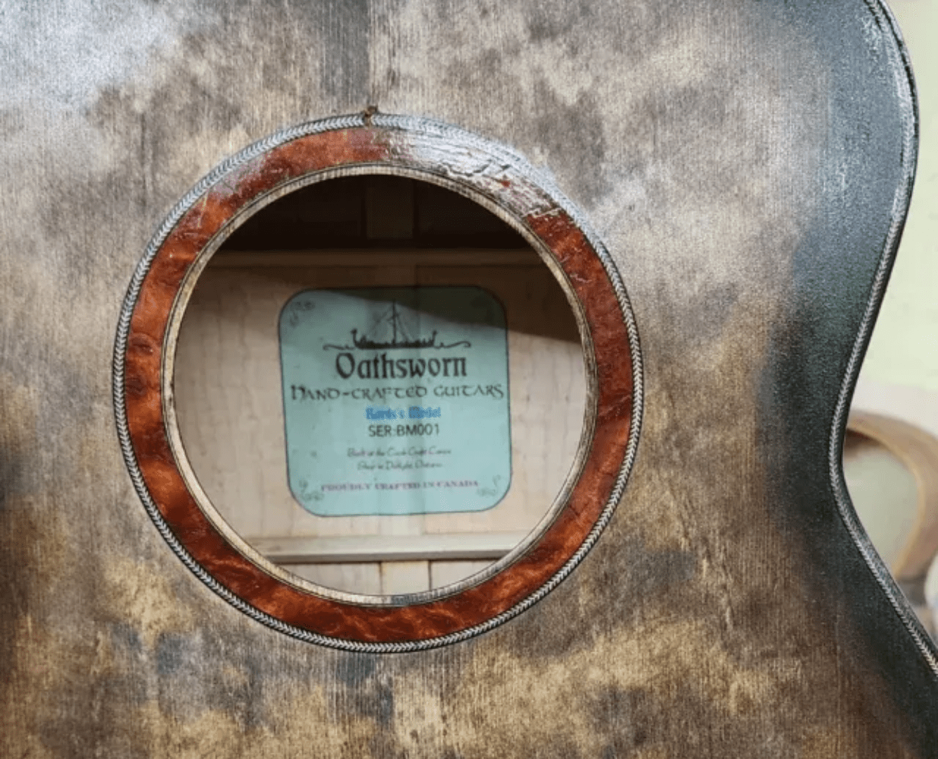 A circular window showing a sign about oak barrels for aging whiskey.